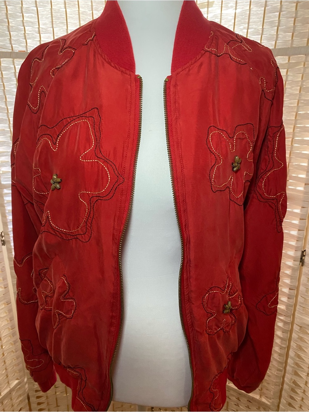 Red boomer jacket by Anne Carson M with floral stitch motif. Polyester, silk